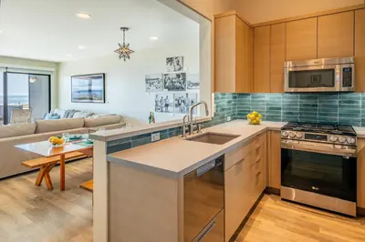 a kitchen with a sink and a stove top oven at Seahorse Cottage by Paradise Retreats in Carpinteria