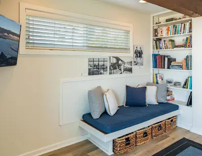 a room with a bench with pillows and a window at Seahorse Retreat by Paradise Retreats in Carpinteria