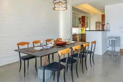 a dining room with a table and chairs at Seascape by Paradise Retreats in Carpinteria