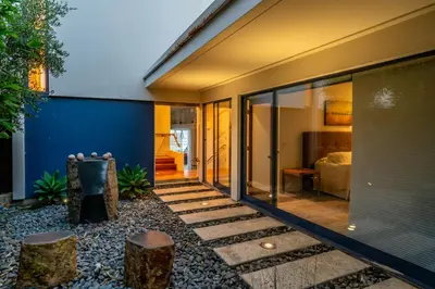 a home with a glass door and a patio at Seascape by Paradise Retreats in Carpinteria