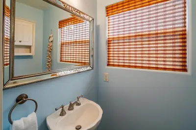 a bathroom with a sink and a mirror at Summer Sunset by Paradise Retreats in Ventura