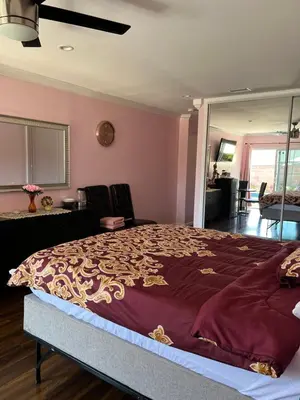 a bedroom with a large bed with a purple blanket at Just The Two Of Us -Romantic Pool View And Private Entry Sleeps 2 Near CSUN CSUN in North Hills
