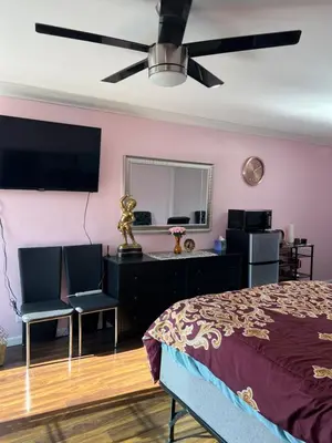 a bedroom with a bed and a desk with two chairs at Just The Two Of Us -Romantic Pool View And Private Entry Sleeps 2 Near CSUN CSUN in North Hills