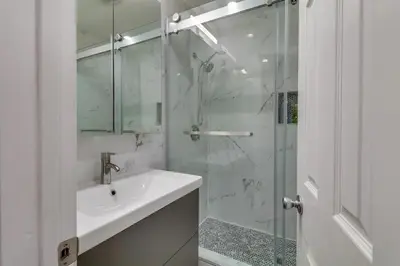a bathroom with a sink and a glass shower at Just The Two Of Us -Romantic Pool View And Private Entry Sleeps 2 Near CSUN CSUN in North Hills