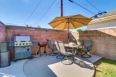 a patio with a table and an umbrella and a grill at Just The Two Of Us -Romantic Pool View And Private Entry Sleeps 2 Near CSUN CSUN in North Hills