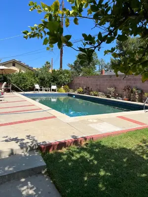 a swimming pool in a yard next to a house at Just The Two Of Us -Romantic Pool View And Private Entry Sleeps 2 Near CSUN CSUN in North Hills