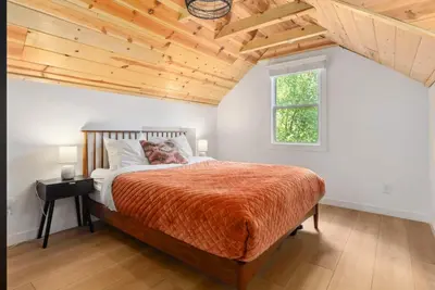a bedroom with a large bed and a window at Newly Renovated Villa 6 Beds Fenced-in Backyard in Big Bear Lake