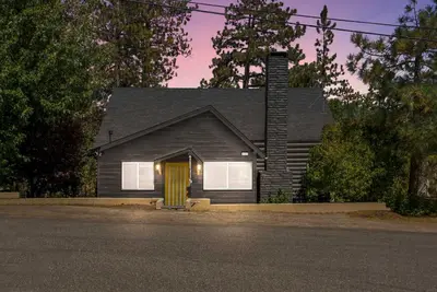 a house with a yellow door on a street at Newly Renovated Villa 6 Beds Fenced-in Backyard in Big Bear Lake