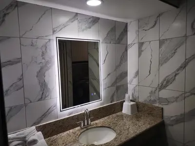 a bathroom with a sink and a mirror at Crzy 8 Motel in Orange