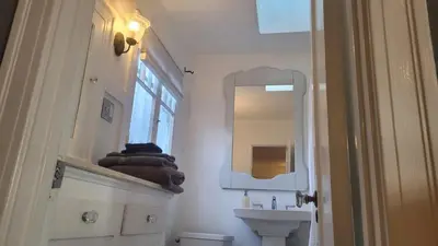 a bathroom with a sink and a mirror at Spacious Studio Six in Hollywood! in Los Angeles