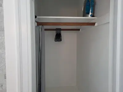 a broom sitting on a shelf next to a door at Hollywood Bungalow One with Patio! in Los Angeles