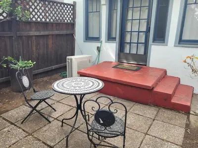 a patio with a table and chairs and a bench at Hollywood Bungalow One with Patio! in Los Angeles