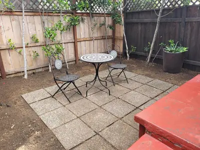 a patio with a table and chairs and a fence at Hollywood Bungalow One with Patio! in Los Angeles