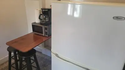 a kitchen with a table and a microwave and a refrigerator at Amazing Hollywood Bungalow Three! in Los Angeles