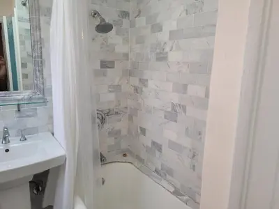 a bathroom with a tub and a sink and a shower at Beautiful Bungalow Five in Hollywood! in Los Angeles