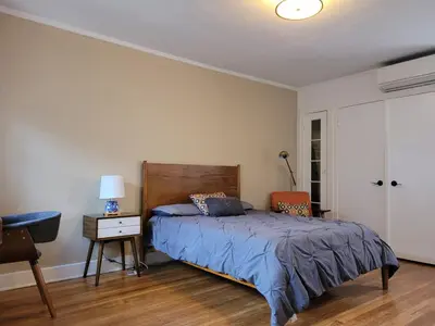 a bedroom with a bed and a desk with a lamp at Beautiful Bungalow Five in Hollywood! in Los Angeles