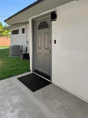 a door to a house with a black mat in front at Modern Home for Large Families by Disney & Knotts in Anaheim