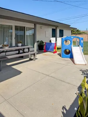 a patio with a picnic table and a playground at Modern Home for Large Families by Disney & Knotts in Anaheim