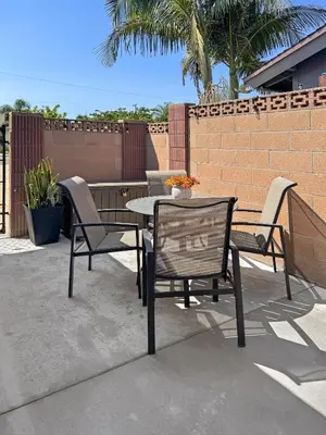 a patio with a table and chairs and a fence at Modern Home for Large Families by Disney & Knotts in Anaheim
