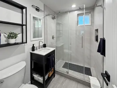 a bathroom with a shower and a toilet and a sink at Modern Home for Large Families by Disney & Knotts in Anaheim