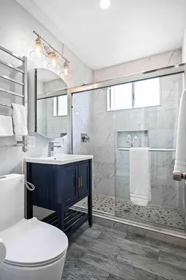 a bathroom with a shower and a toilet and a sink at Elegant Beachside 2 Bed 2 Bath in Long Beach