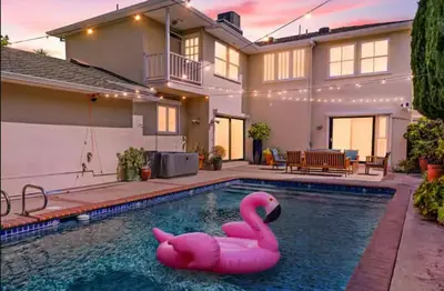 a pink swan in a swimming pool in front of a house at Beverly Hills 6BR Haven w Pool Hot Tub in Los Angeles