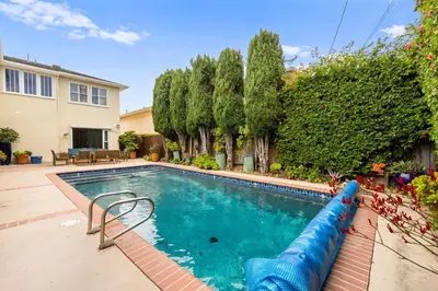 a swimming pool with a blue water slide in a yard at Beverly Hills 6BR Haven w Pool Hot Tub in Los Angeles