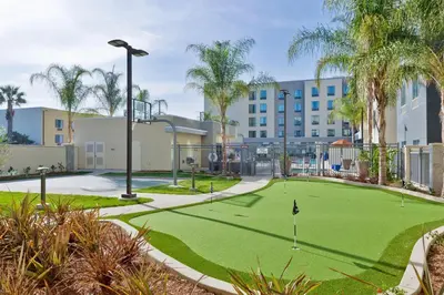 a golf course in front of a hotel with palm trees at Homewood Suites by Hilton Anaheim Conv Ctr/Disneyland Main in Anaheim