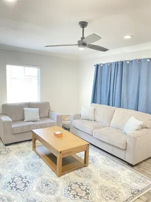 a living room with a couch and a coffee table at HubCityJewel in Compton