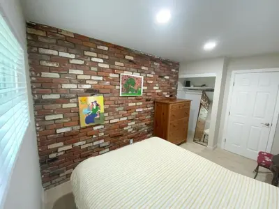 a bedroom with a brick wall and a bed at In a quiet neighborhood near the Main Street-Room C in Rowland Heights