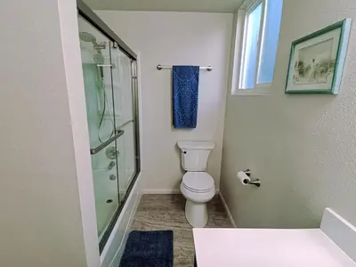 a bathroom with a toilet and a glass shower at In a quiet neighborhood near the Main Street-Room C in Rowland Heights