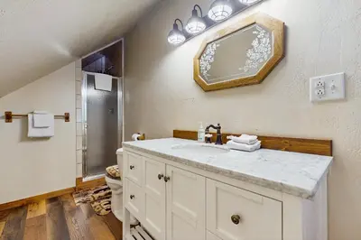 a bathroom with a sink and a shower at Sugar Pine Retreat in Twin Peaks