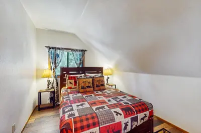 a bedroom with a bed with a quilt on it at Sugar Pine Retreat in Twin Peaks
