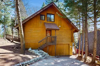 a cabin in the woods with a staircase in front at Sugar Pine Retreat in Twin Peaks