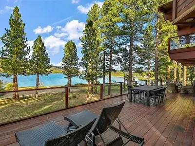 a deck with chairs and a table and a view of the water at Bear Lake Lodge #2547 in Big Bear Lake