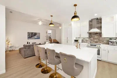 a kitchen and living room with a white counter and chairs at Castlewood Retreat #2524 in Big Bear Lake