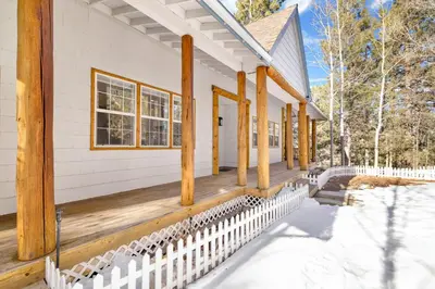 a porch of a house with a white fence at Castlewood Retreat #2524 in Big Bear Lake