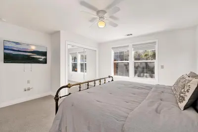 a white bedroom with a bed with a ceiling fan at Castlewood Retreat #2524 in Big Bear Lake