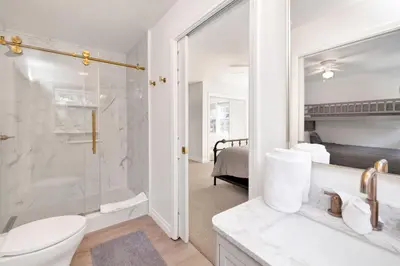 a white bathroom with a shower and a toilet at Castlewood Retreat #2524 in Big Bear Lake