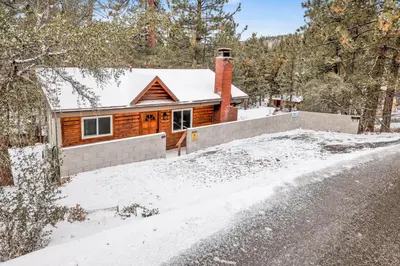 a house in the snow with a driveway at Suenos Azules #2517 in Fawnskin