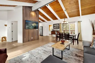 a living room and dining room with a table and chairs at Suenos Azules #2517 in Fawnskin