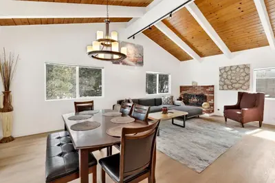 a dining room and living room with a table and chairs at Suenos Azules #2517 in Fawnskin