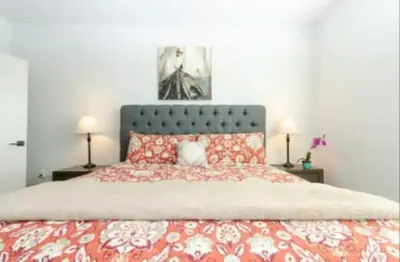 a bedroom with a large bed with red pillows at Cozy 2 Bedroom Apartment Near Disneyland and Anaheim Convention Center in Orange