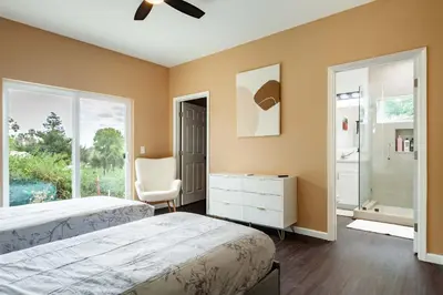 a bedroom with two beds and a chair and a window at Cozy 2BR Home Mountain Views Pet Friendly in Thousand Oaks