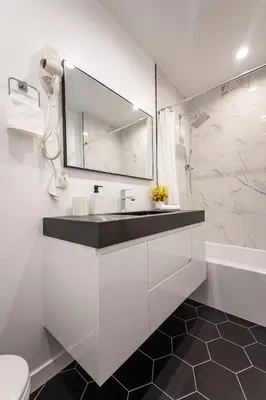 a white bathroom with a sink and a shower at Gated Private Home next to Universal Studios in Van Nuys County Court Heliport