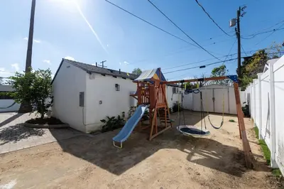 a playground with a slide in a backyard at Gated Private Home next to Universal Studios in Van Nuys County Court Heliport