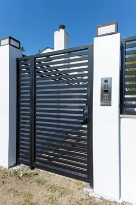 a black metal gate with two white refrigerators at Gated Private Home next to Universal Studios in Van Nuys County Court Heliport