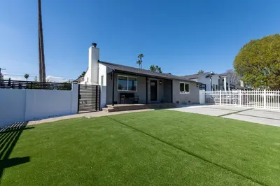 a house with a green lawn in front of it at Gated Private Home next to Universal Studios in Van Nuys County Court Heliport