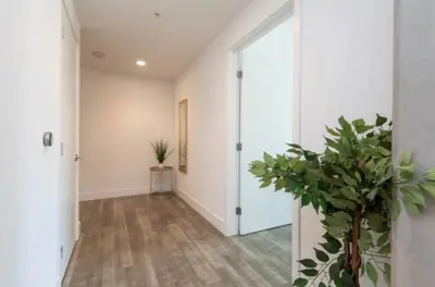 a hallway with a door and a potted plant at Snazzy 3 Bedroom High Rise with Pool, Hot Tub and Rooftop Deck in Los Angeles