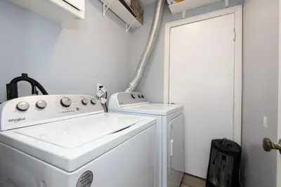 a white laundry room with a washer and dryer at Spacious 3 Bedroom 2 Bathroom Apartment with Free Onsite Parking in Los Angeles